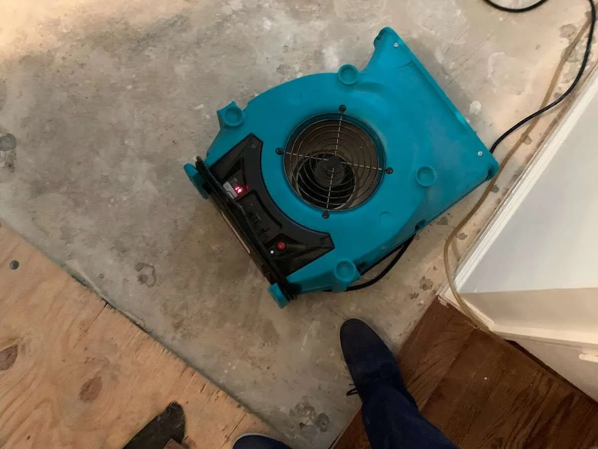 Air mover drying subfloor during Commercial Water Damage Restoration in Delavan